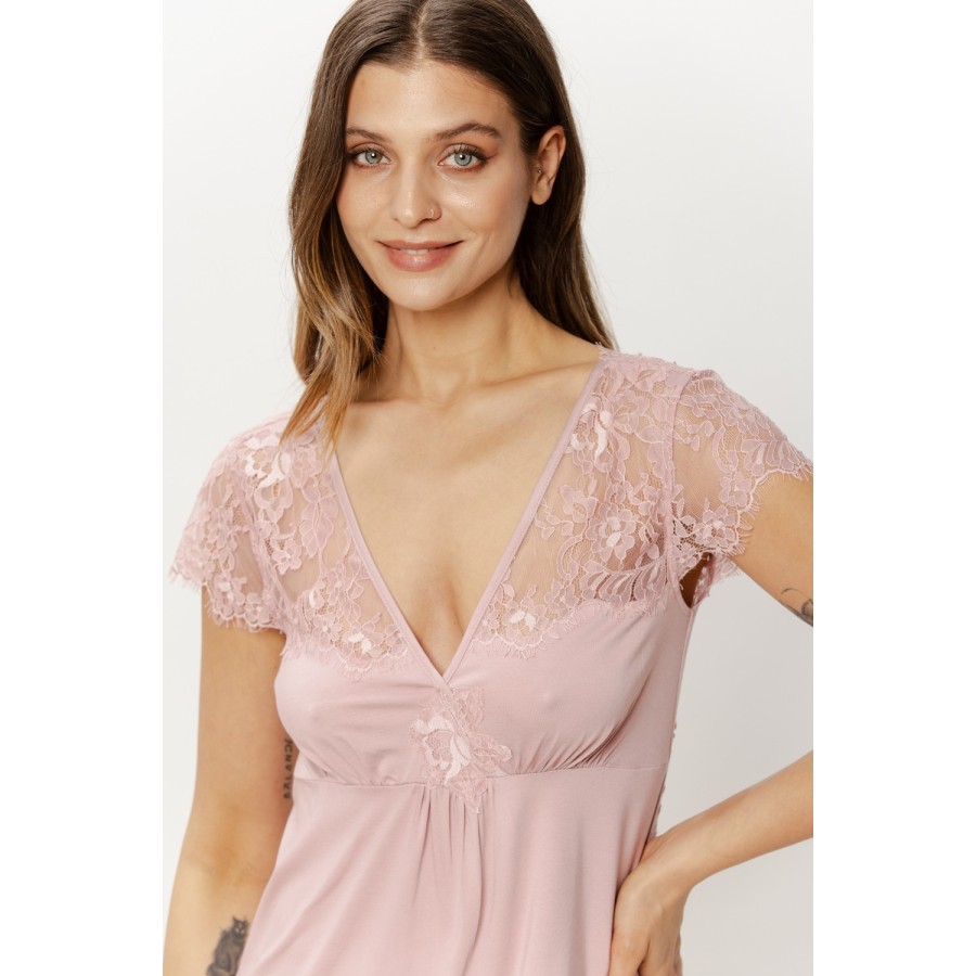 Detail of soft viscose fabric and openwork lace trim on pink nightgown