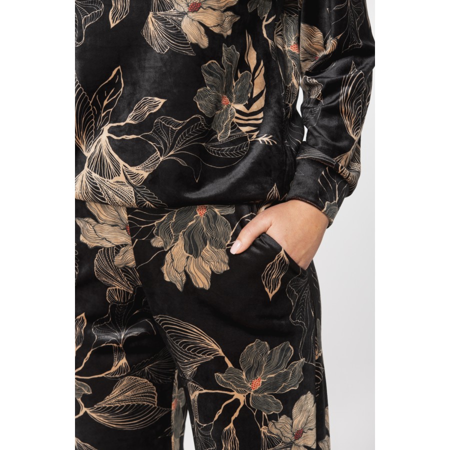 Velvet loungewear outfit printed with sketches of golden flowers on a black background