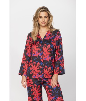 Satin pyjamas in a blue and red print on a black background, nightshirt-style top and bottoms