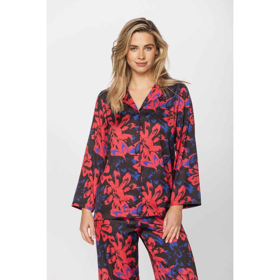 Satin pyjamas in a blue and red print on a black background, nightshirt-style top and bottoms