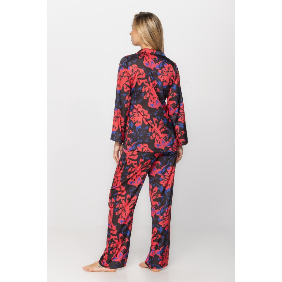 Satin pyjamas in a blue and red print on a black background, nightshirt-style top and bottoms