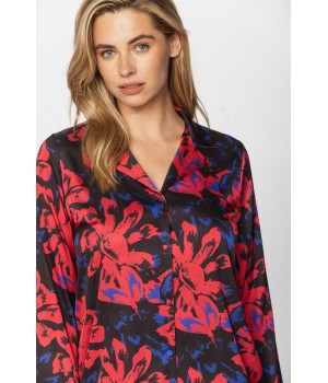 Satin pyjamas in a blue and red print on a black background, nightshirt-style top and bottoms