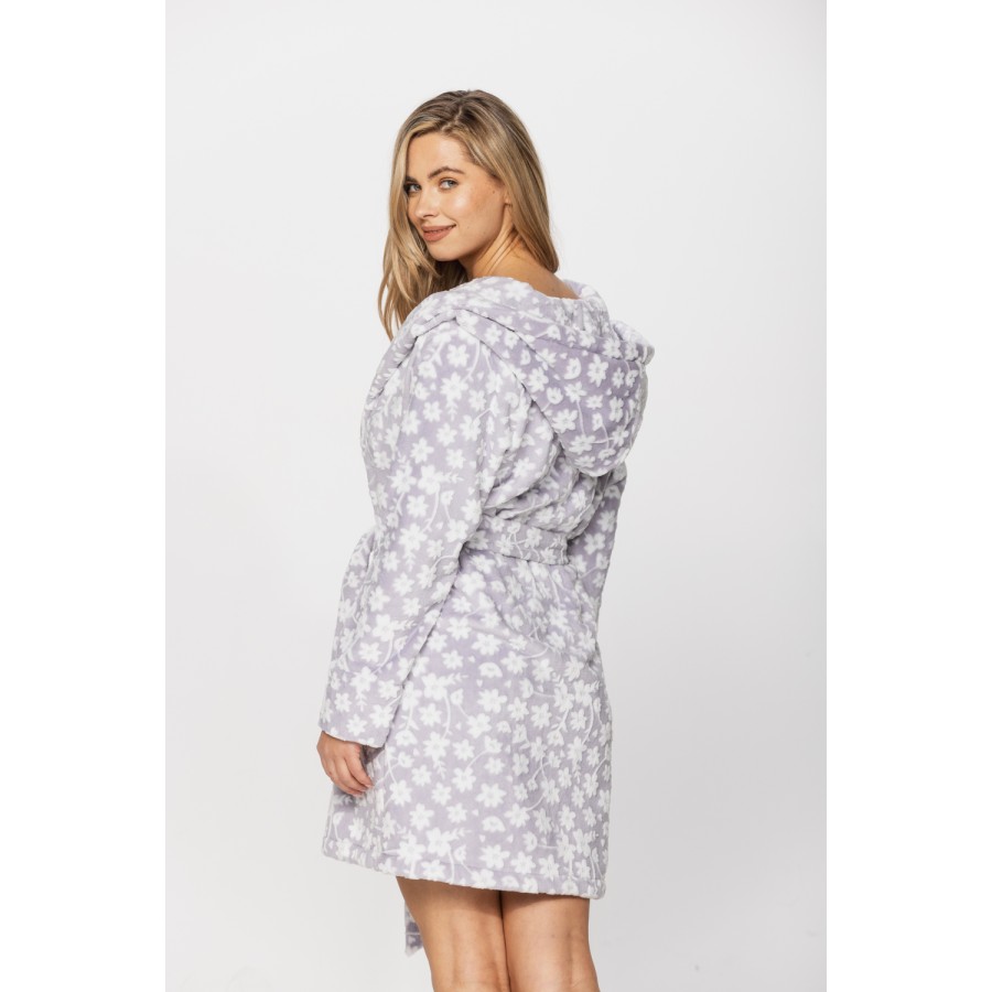 Gorgeous little bathrobe with hood in warm velvet and a floral print on a grey background