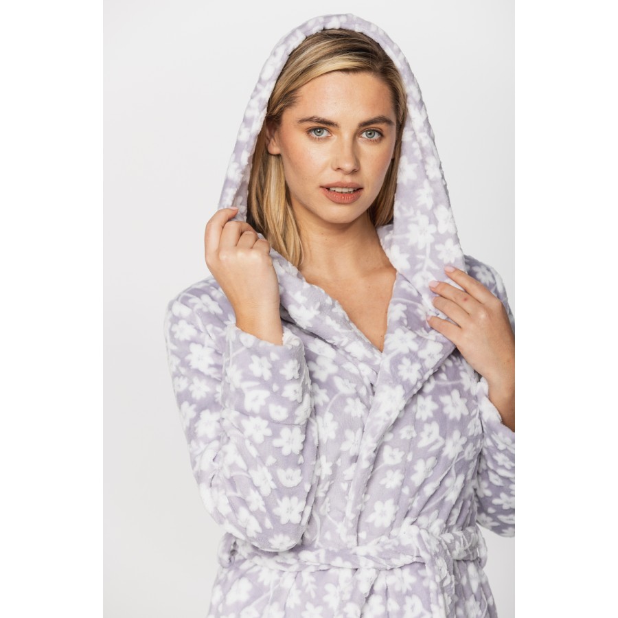 Gorgeous little bathrobe with hood in warm velvet and a floral print on a grey background