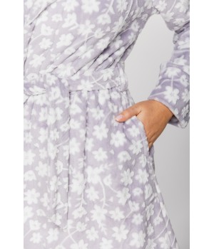 Gorgeous little bathrobe with hood in warm velvet and a floral print on a grey background