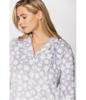 Warm velvet loungewear outfit, button-up top and straight-cut bottoms with floral print on a grey background