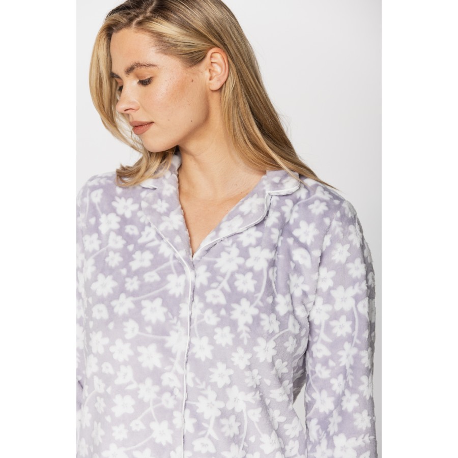 Warm velvet loungewear outfit, button-up top and straight-cut bottoms with floral print on a grey background