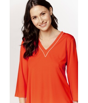 Loose-fitting silk pajama set with V-neck trim, pants, and ¾ sleeves