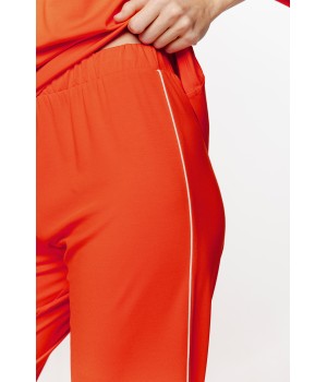 Loose-fitting silk pajama set with V-neck trim, pants, and ¾ sleeves