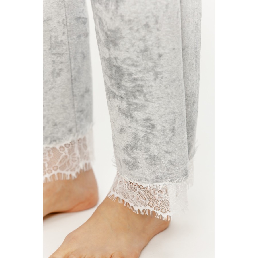 Side view of grey velvet-touch pajama pants showing elastic waist and pocket