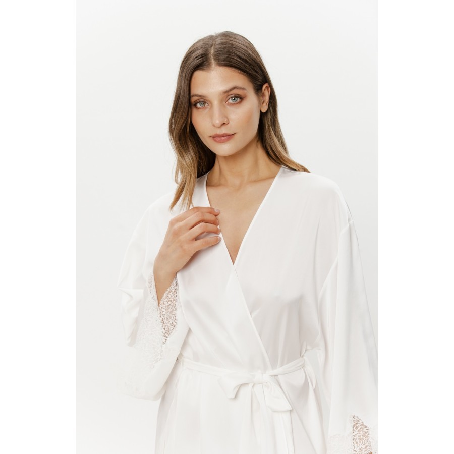 Close-up of the open front and waist tie of a white satin robe with lace cuffs